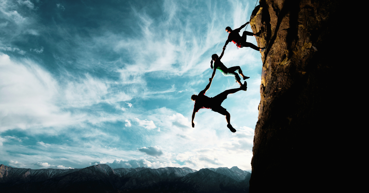 stylised image of a group of 3 people all hanging off of a cliff with their arms linked. They form a chain from the top to the last person - conveying a sense of trust. 